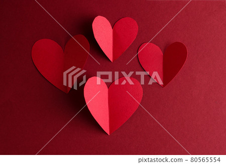 Red paper Hearts on a dark red background. Valentines Day monochrome concept card. Red paper Hearts on a dark red background. Valentines Day monochrome concept card. 80565554