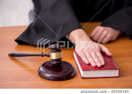 Young male judge working in the courtroom 80566594