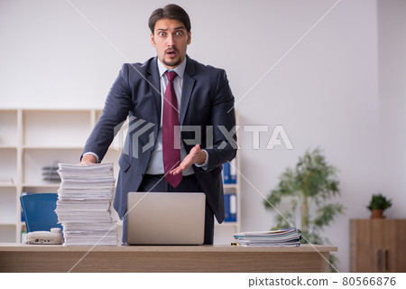 Young male employee working in the office Young male employee working in the office 80566876