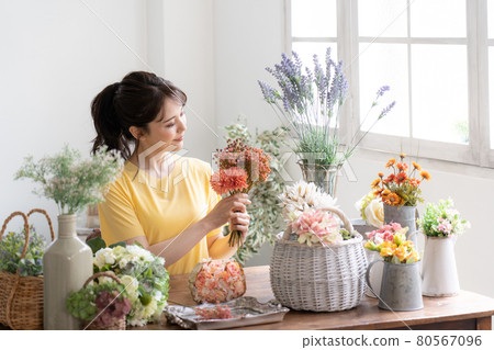A woman with a flower arrangement A woman with a flower arrangement 80567096