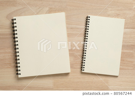 two blank spiral notebook on wooden table for mockup blank template 80567244