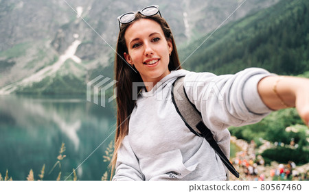 Blogger girl. Young female travel photographer with smartphone on summer mountain rock nature background. Freedom, summer travel, profession concept. Blogger girl. Young female travel photographer with smartphone on summer mountain rock nature background. Freedom, summer travel, profession concept. 80567460