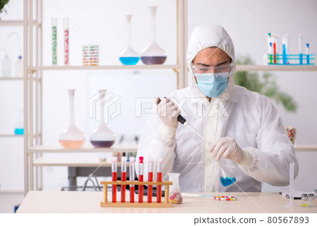 Young male chemist in drugs syntesis concept 80567893