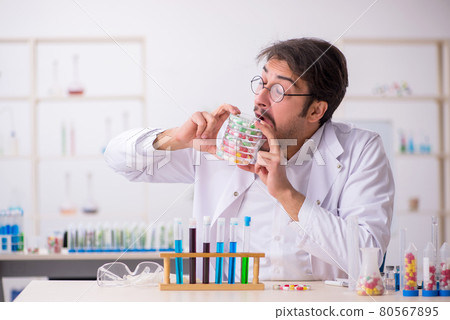 Young male chemist in drugs synthesis concept 80567895