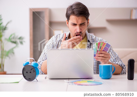 Young male freelancer in time management concept at home Young male freelancer in time management concept at home 80568910