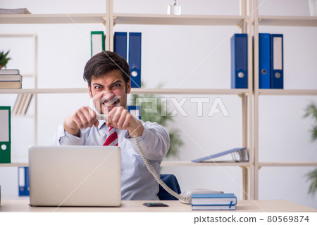 Young male employee working in the office 80569874