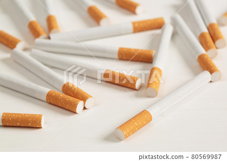 image of several commercially made pile cigarette on white background. or Non smoking campaign concept, tobacco pattern top view. image of several commercially made pile cigarette on white background. or Non smoking campaign concept, tobacco pattern top view. 80569987