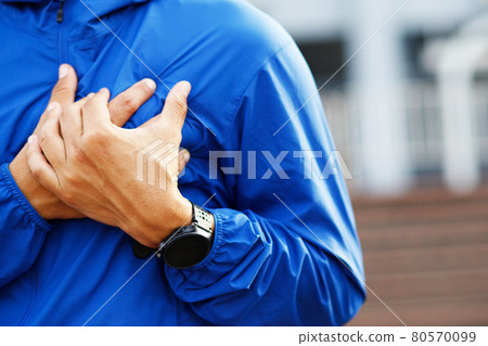 Jogging running athlete man having chest pain - Stock Photo