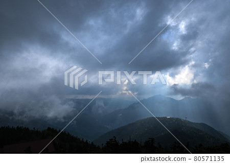 Mountains of the Northern Alps peeking through the clouds Mountains of the Northern Alps peeking through the clouds 80571135