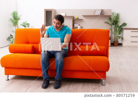 Young male student in tele-studying concept during pandemic Young male student in tele-studying concept during pandemic 80571259