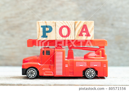 Fire ladder truck hold letter block in word POA (Abbreviation of Plan of action, Power of attorney, Period of availability or Paid on arrival) on wood background Fire ladder truck hold letter block in word POA (Abbreviation of Plan of action, Power of attorney, Period of availability or Paid on arrival) on wood background 80571556