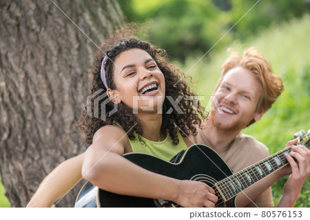 Laughing happy girl with guy in nature Laughing happy girl with guy in nature 80576153