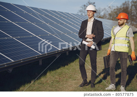 Foreman and businessman at solar energy station. 80577875