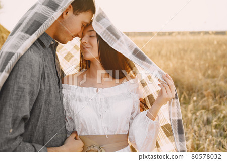 Happy couple in love in wheat field at sunset Happy couple in love in wheat field at sunset 80578032