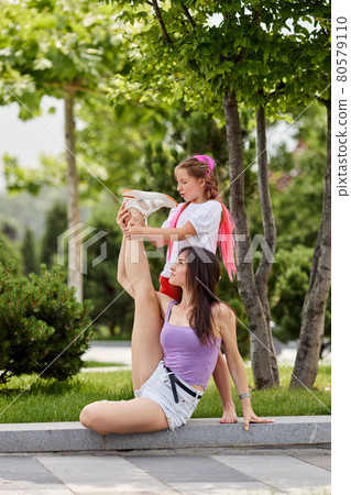 child girl and her mother having fun in park. child girl and her mother having fun in park. 80579110
