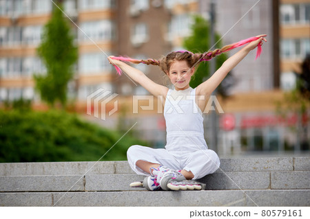 cute little girl on roller skates at park. cute little girl on roller skates at park. 80579161