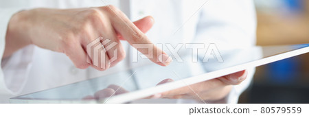 Medical officer doctor points his finger at tablet Medical officer doctor points his finger at tablet 80579559