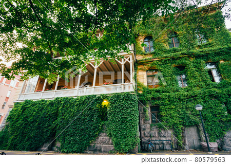 Wall Of House With Window Covered With Ivy 80579563