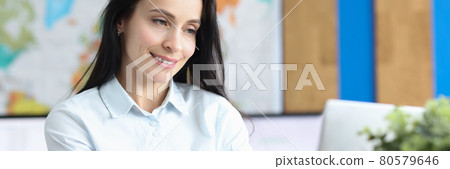 Young smiling woman working on laptop closeup Young smiling woman working on laptop closeup 80579646