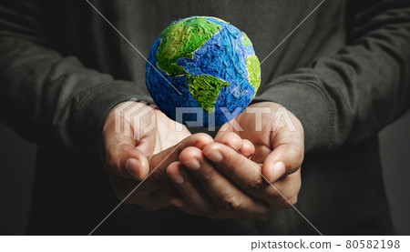 World Earth Day Concept. Green Energy, Renewable and Sustainable Resources. Environmental and Ecology Care. Hand Levitating a Green Handmade Globe 80582198
