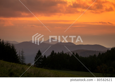 Mountains colored in shades of orange at sunset in autumn. 80582621
