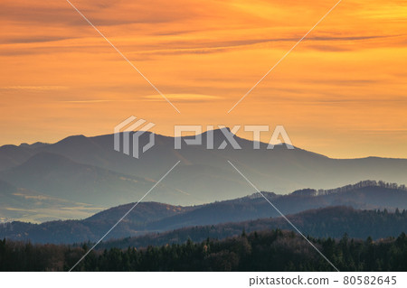 Mountains colored in shades of orange at sunset in autumn. 80582645