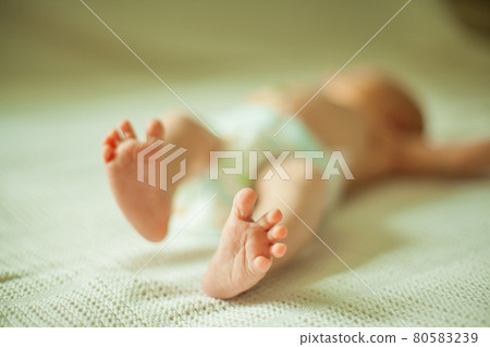 health concept - closeup of legs of a newborn baby lying health concept - closeup of legs of a newborn baby lying 80583239
