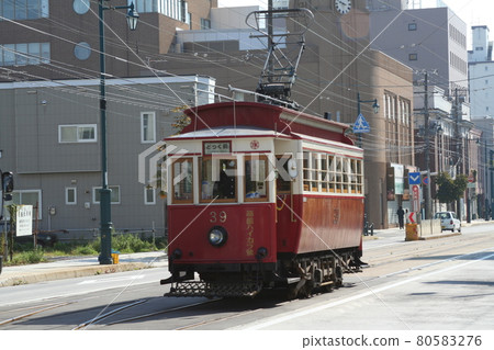 Restoration train Haikara-go Hakodate streetcar going through the Important Preservation District for Groups of Traditional Buildings Motomachi Hokkaido 80583276