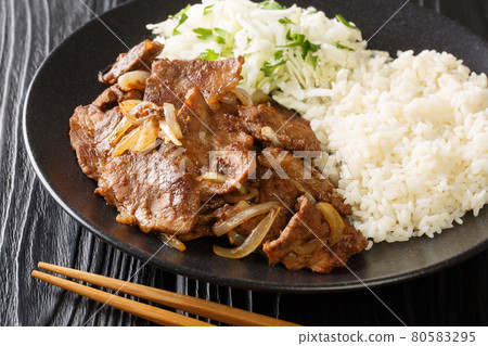 Pork Shogayaki is a dish in Japanese cuisine with rice and cabbage salad closeup in the plate. horizontal 80583295