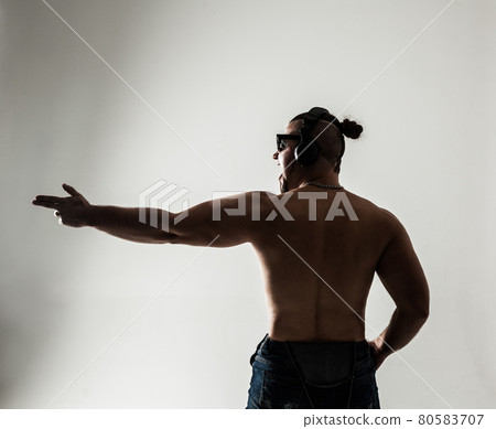 rear view - creative rapper in the headphones and dark glasses 80583707