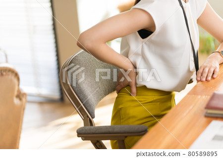 Suffering from back pain 80589895