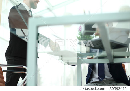 bottom view.the background image of handshake of business partners on a Desk bottom view.the background image of handshake of business partners on a Desk 80592411