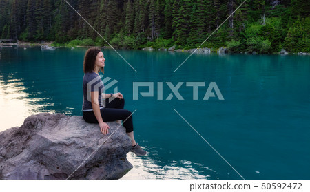 Adventurous White Caucasin Adult Woman Hiking on a trail in Canadian Nature 80592472