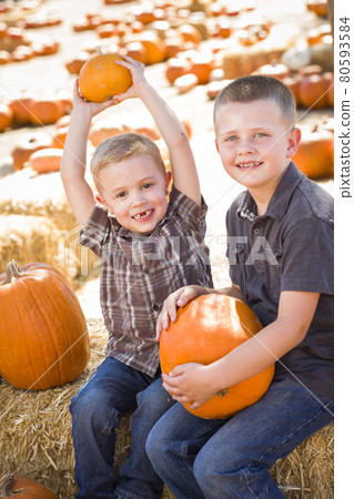 Two Boys Having Fun at the Pumpkin Patch on a Fall Day... 80593584