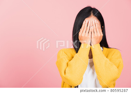 young woman in depressed bad mood her cry close face by hands 80595287