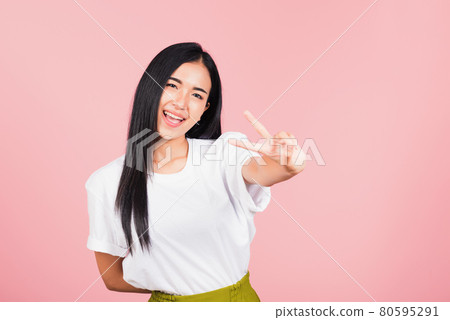 woman teen smile standing showing finger making v-sign victory symbol 80595291