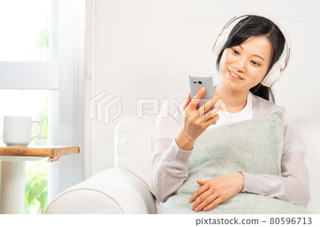 A woman enjoying music A woman enjoying music 80596713