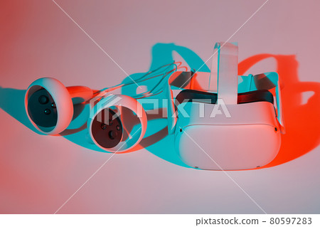 Virtual reality helmet and controllers on white background in neon light 80597283