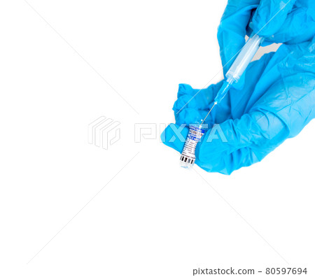 The coronavirus vaccine is in the hands of a doctor, a syringe The coronavirus vaccine is in the hands of a doctor, a syringe 80597694