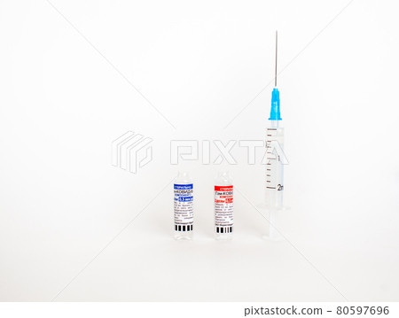 The coronavirus vaccine is in the hands of a doctor, a syringe 80597696