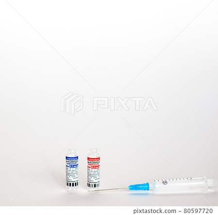The coronavirus vaccine is in the hands of a doctor, a syringe The coronavirus vaccine is in the hands of a doctor, a syringe 80597720