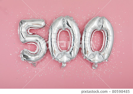 Silver balloon showing number 500 on pink background Silver balloon showing number 500 on pink background 80598485