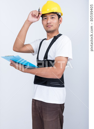 Worker Man stand write book note wearing back support Worker Man stand write book note wearing back support 80599405