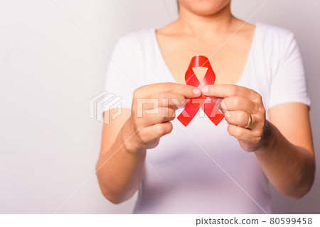 Closeup of female with red ribbon Support HIV AIDS on hands Closeup of female with red ribbon Support HIV AIDS on hands 80599458