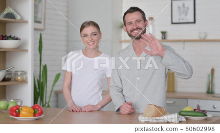 Woman and Man Talking on Video Call in Kitchen Woman and Man Talking on Video Call in Kitchen 80602998