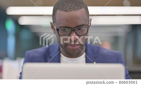 Young African Businessman Working on Laptop in Office Young African Businessman Working on Laptop in Office 80603001