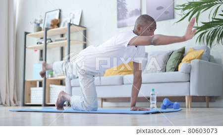 African Man doing Workout on Yoga Mat at Home African Man doing Workout on Yoga Mat at Home 80603073
