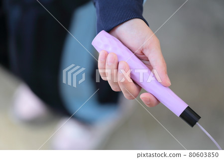 A woman playing sports with a skipping rope 80603850