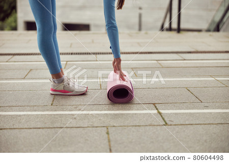 Young fit lady is doing fitness and jogging at urban place 80604498