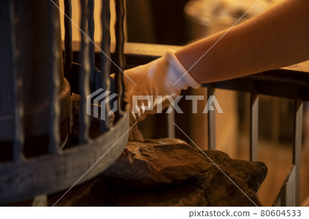 the hands of the master lay stones in the sauna stove the hands of the master lay stones in the sauna stove 80604533